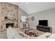 Cozy living room with a brick fireplace, wood floors, and neutral decor at 1940 Canterbury Dr, Las Vegas, NV 89119