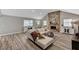 Inviting living room with a brick fireplace, stylish furniture, and wood-look laminate flooring at 1940 Canterbury Dr, Las Vegas, NV 89119