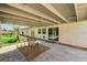Covered patio with seating overlooking the lush backyard at 1940 Canterbury Dr, Las Vegas, NV 89119