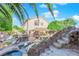 Beautiful backyard showcasing a custom pool, outdoor kitchen, and stunning rock features at 204 Appian Way, Henderson, NV 89002