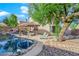 Lush backyard with a custom pool, outdoor kitchen, and seating area, perfect for entertaining at 204 Appian Way, Henderson, NV 89002