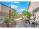 View of the landscaped backyard featuring desert landscaping, patio, and Tiki carving at 204 Appian Way, Henderson, NV 89002