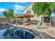 Backyard oasis featuring a custom pool, lounge chairs, and covered outdoor kitchen at 204 Appian Way, Henderson, NV 89002