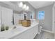 Bright bathroom featuring double sinks, a large mirror, and tile flooring at 204 Appian Way, Henderson, NV 89002