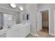 Bright primary bathroom boasts double sinks, shower, and shuttered window for natural light at 204 Appian Way, Henderson, NV 89002