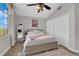 Neutral bedroom featuring a ceiling fan, a full-length mirror, and a spacious closet at 204 Appian Way, Henderson, NV 89002