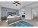 Spacious bedroom boasts a neutral color scheme, ceiling fan, and plush blue rug at 204 Appian Way, Henderson, NV 89002