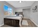 Bright bedroom with neutral walls, a modern ceiling light, and a large window for natural light at 204 Appian Way, Henderson, NV 89002
