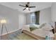Bright bedroom featuring a ceiling fan, a window, and a white closet door at 204 Appian Way, Henderson, NV 89002