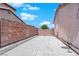Concrete driveway and brick wall that extends along the side of this desert home at 204 Appian Way, Henderson, NV 89002