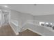Upstairs hallway features light walls and carpet, a white banister, and multiple room entries at 204 Appian Way, Henderson, NV 89002