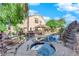 Backyard featuring a pool, hot tub, covered patio, and a built-in outdoor kitchen and bar at 204 Appian Way, Henderson, NV 89002