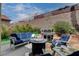 Outdoor seating area with a grill, fire pit, and comfortable couch perfect for entertaining at 2078 Wildwood Lake St, Henderson, NV 89052