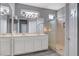 Bright bathroom with double sinks, a large mirror, modern lighting, and a glass-enclosed shower at 2078 Wildwood Lake St, Henderson, NV 89052