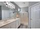 Bright bathroom with double sinks, a large mirror, modern lighting, and a glass-enclosed shower at 2078 Wildwood Lake St, Henderson, NV 89052