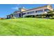 Expansive clubhouse exterior view featuring lush green lawns and beautifully landscaped grounds at 2078 Wildwood Lake St, Henderson, NV 89052