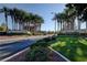 Inviting entrance to Sun City Anthem with palm trees, manicured lawns and landscaped features at 2078 Wildwood Lake St, Henderson, NV 89052