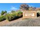 Elegant 'Clubhouse Village' community sign surrounded by lush greenery and well-maintained landscaping at 2078 Wildwood Lake St, Henderson, NV 89052