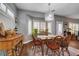 Charming dining room features hardwood floors, custom buffet, decorative light fixture, and beautiful bay window views at 2078 Wildwood Lake St, Henderson, NV 89052