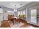 Bright dining room with bay window, wood floors, and access to outdoor patio space at 2078 Wildwood Lake St, Henderson, NV 89052