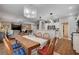 Open concept living with direct access to the kitchen, dining room with chandelier and hardwood floors at 2078 Wildwood Lake St, Henderson, NV 89052
