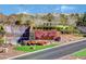 Community entrance featuring a cascading waterfall, rock details, and manicured landscaping at 2078 Wildwood Lake St, Henderson, NV 89052