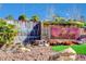 Beautiful entrance waterfall feature complemented by vibrant landscaping at 2078 Wildwood Lake St, Henderson, NV 89052