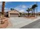 Inviting single-Gathering home with desert landscaping and a driveway leading to a two-car garage at 2078 Wildwood Lake St, Henderson, NV 89052