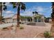 Attractive home with a well-maintained front yard, desert landscaping, and mature palm trees at 2078 Wildwood Lake St, Henderson, NV 89052
