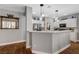 Bright kitchen with stainless steel appliances, stone countertops, and hardwood flooring at 2078 Wildwood Lake St, Henderson, NV 89052