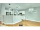 Bright, open-concept kitchen with white cabinetry, stainless steel appliances, and hardwood floors at 2078 Wildwood Lake St, Henderson, NV 89052