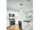 Modern kitchen with stainless steel appliances, white cabinets, and hardwood floors at 2078 Wildwood Lake St, Henderson, NV 89052