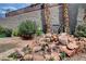Intricate rock and flower landscaping create a lovely feature in this serene backyard space at 2078 Wildwood Lake St, Henderson, NV 89052