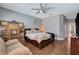 Comfortable main bedroom featuring hardwood floors, ceiling fan, and well-lit sitting area at 2078 Wildwood Lake St, Henderson, NV 89052