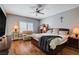 Comfortable main bedroom featuring hardwood floors, ceiling fan, and well-lit sitting area at 2078 Wildwood Lake St, Henderson, NV 89052