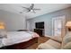 Comfortable main bedroom featuring hardwood floors, ceiling fan, and sitting area with outdoor access at 2078 Wildwood Lake St, Henderson, NV 89052