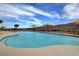 Beautiful community outdoor pool features shaded lounge areas, mountain views, and refreshing blue water at 2078 Wildwood Lake St, Henderson, NV 89052