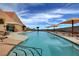 Scenic outdoor community pool with multiple lounge areas and inviting blue water, under a bright sky at 2078 Wildwood Lake St, Henderson, NV 89052