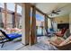 Inviting covered patio with a ceiling fan, multiple seating areas, and pool at 2078 Wildwood Lake St, Henderson, NV 89052