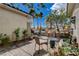 Cozy patio with outdoor seating, lush plants and views of the palm tree-lined street at 2078 Wildwood Lake St, Henderson, NV 89052