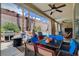 Covered patio with outdoor seating, grill, fire pit, and view of the pool at 2078 Wildwood Lake St, Henderson, NV 89052