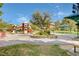 Community playground featuring colorful slides and a swing set surrounded by landscaped areas for outdoor fun at 2078 Wildwood Lake St, Henderson, NV 89052