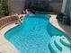Inviting pool with a rock waterfall feature, perfect for relaxation and outdoor enjoyment at 2078 Wildwood Lake St, Henderson, NV 89052