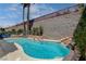 Enjoy a refreshing swim in the sparkling in-ground pool with a rock waterfall feature, ideal for relaxation at 2078 Wildwood Lake St, Henderson, NV 89052