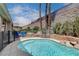 Inviting in-ground pool with rock waterfall and sun loungers, perfect for enjoying the outdoors in style at 2078 Wildwood Lake St, Henderson, NV 89052