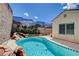 Private in-ground pool, rock waterfall and manicured gardens create an oasis for backyard fun and relaxation at 2078 Wildwood Lake St, Henderson, NV 89052