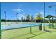 Multiple well-maintained tennis courts with lights for evening play and viewing area at 2078 Wildwood Lake St, Henderson, NV 89052