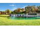 Serene pond at Anthem Country Club with gentle waterfalls, mature trees, and picturesque landscaping at 2078 Wildwood Lake St, Henderson, NV 89052