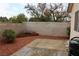 Backyard showcasing a patio area, rock landscaping, flowerbed, and block wall fence at 2148 Hidden Ranch Ter, Henderson, NV 89052