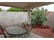Covered patio with outdoor seating and xeriscape garden featuring a cactus display at 2148 Hidden Ranch Ter, Henderson, NV 89052